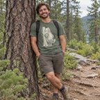 Man leaning on a pine tree wearing the Back Scratch Bear T-Shirt