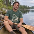 Man in a canoe wearing the Bear in a Canoe T-Shirt