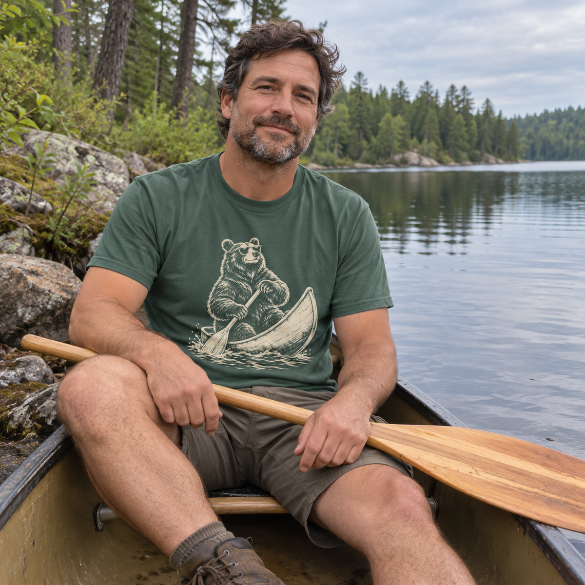 Man in a canoe wearing the Bear in a Canoe T-Shirt