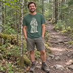 Man wearing the Bigfoot Hide and Seek T-Shirt on a forest trail