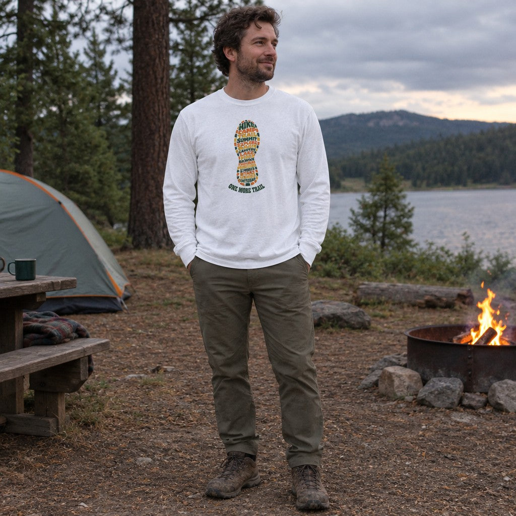 Man wearing the One More Trail long sleeve shirt at a campsite in the evening