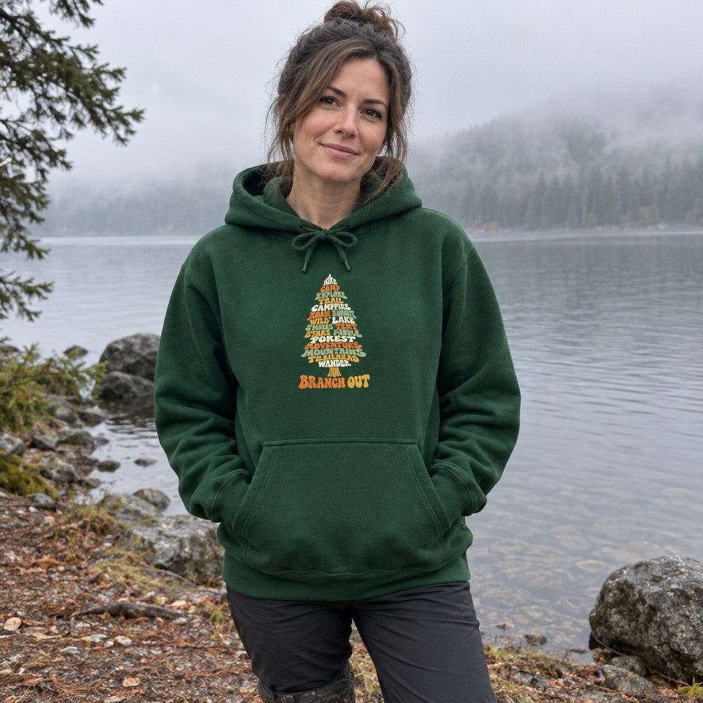Woman wearing the Branch Out hoodie on a misty lakeshore in the morning