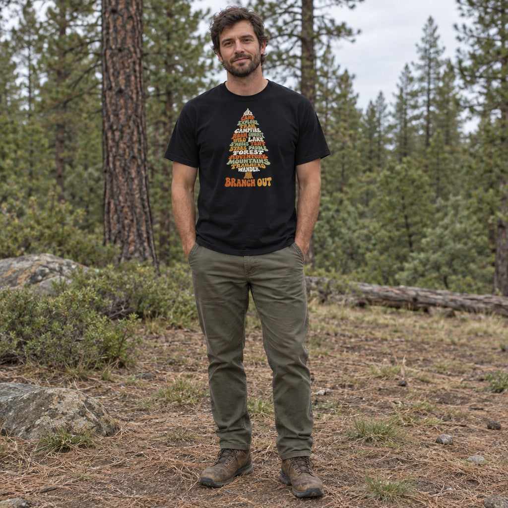 Man wearing the Branch Out T-shirt in a pine forest clearing