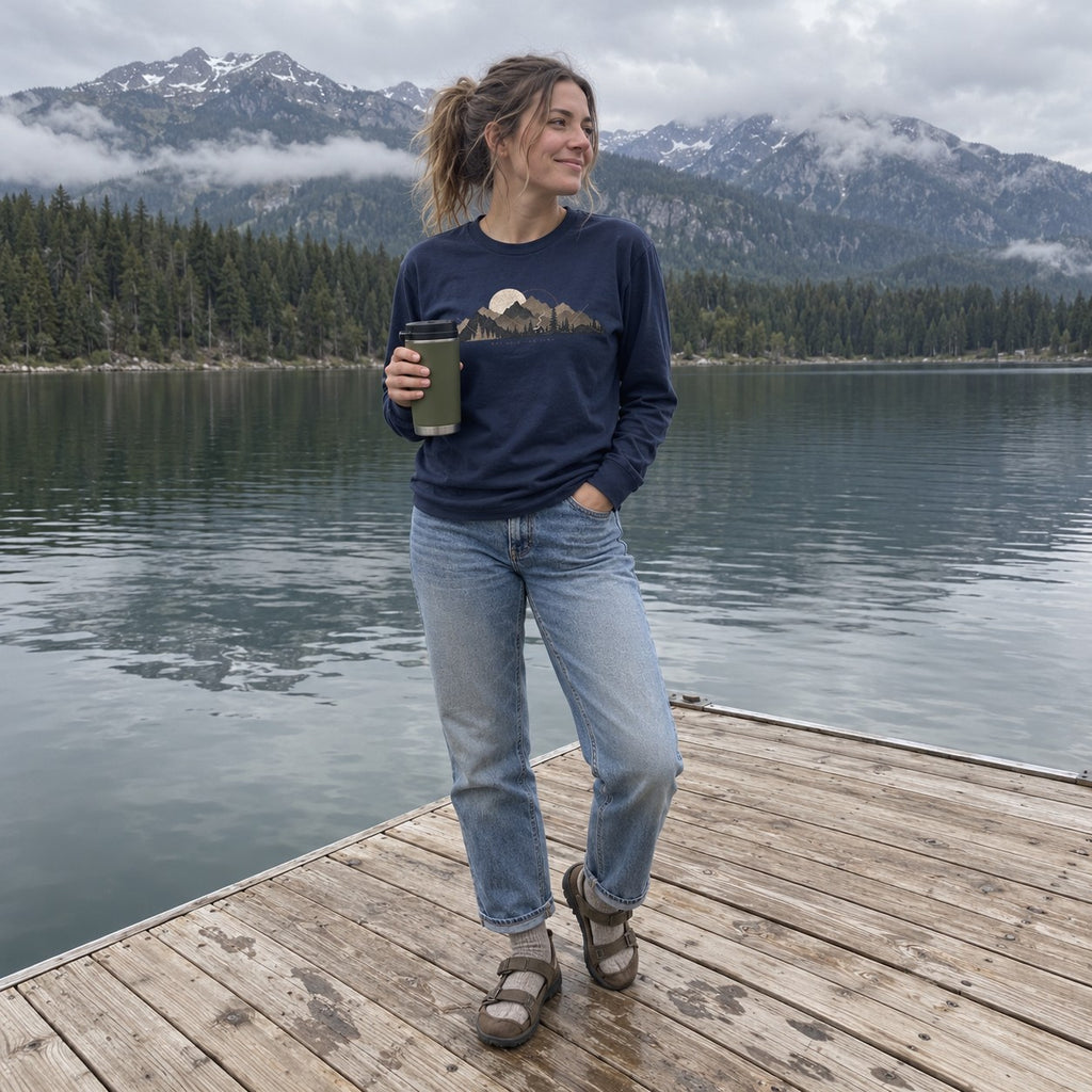 Woman wearing the Cabin Smoke Long Sleeve Shirt in Navy on a lake dock