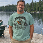 Man wearing the Cannonball Season bear T-shirt on a lake dock