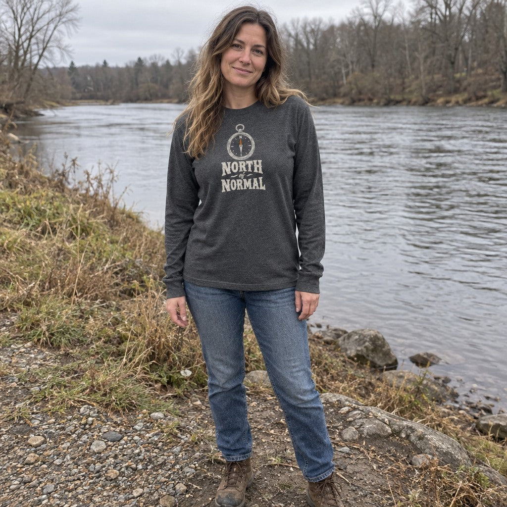 Woman wearing the North of Normal long sleeve shirt by a river bank