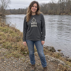 Woman wearing the North of Normal long sleeve shirt by a river bank