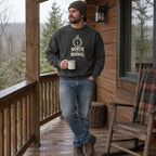 Man wearing the North of Normal crewneck sweatshirt on a cabin porch with a mug