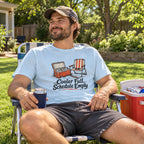Man wearing the Cooler Full, Schedule Empty T-Shirt in a lawn chair
