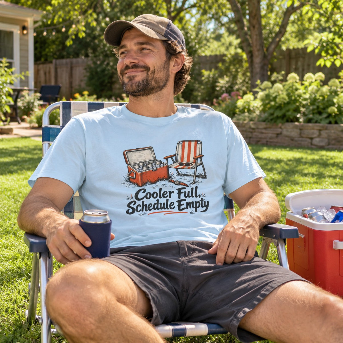 Man wearing the Cooler Full, Schedule Empty T-Shirt in a lawn chair