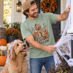 Man wearing the Curls & Cobwebs T-Shirt decorating with his labradoodle