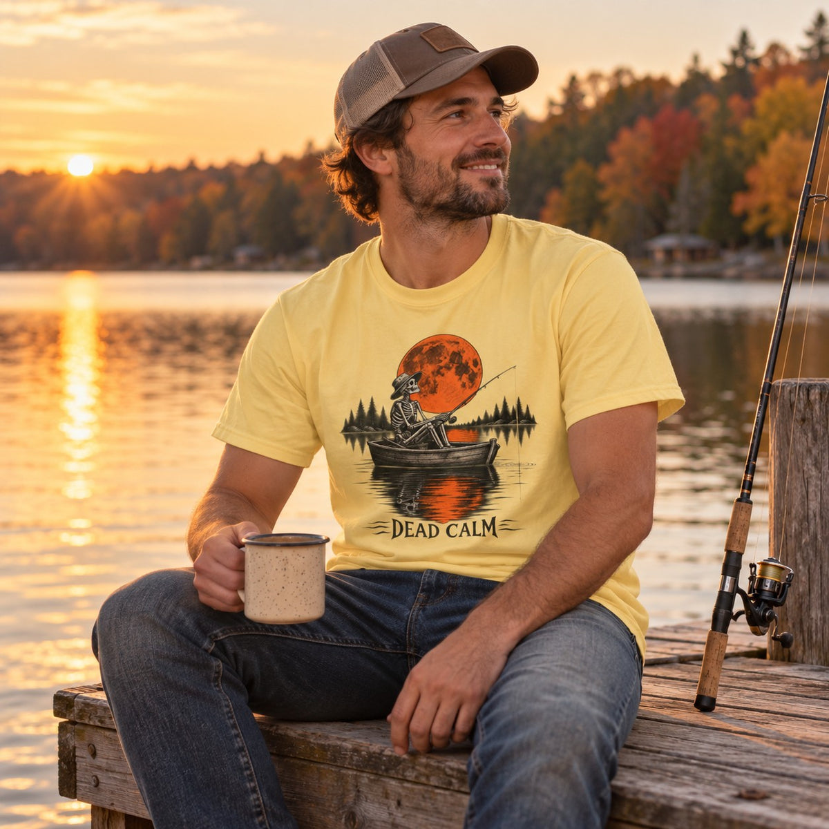 Man wearing the Dead Calm skeleton fishing t-shirt on a lake dock at sunset