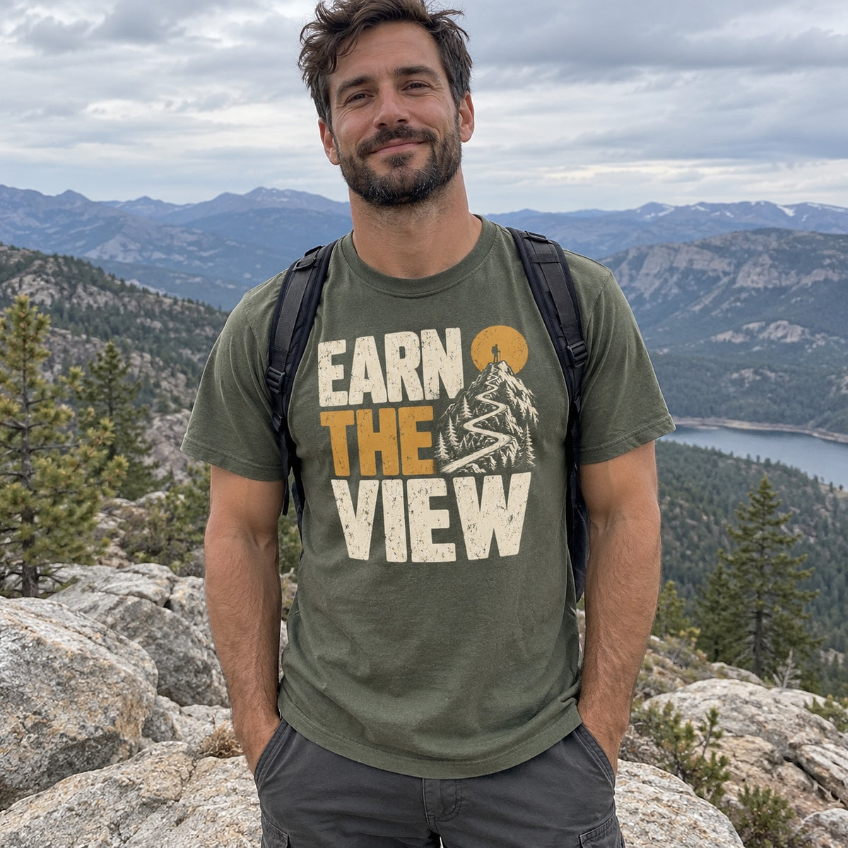 Man wearing the Earn the View T-Shirt at a mountain overlook