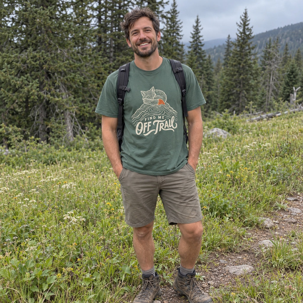 Man wearing the Find Me Off Trail T-shirt outdoors