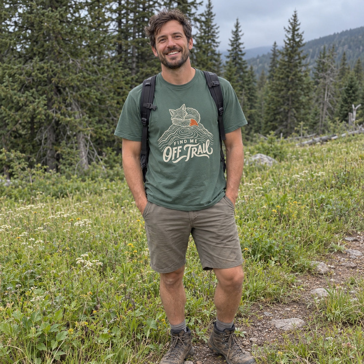 Man wearing the Find Me Off Trail T-shirt outdoors