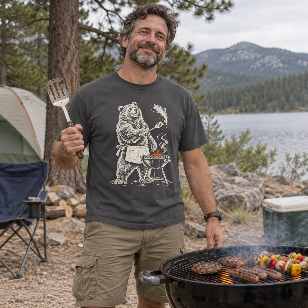 Man grilling at a campsite wearing the Grill Master Grizzly T-Shirt
