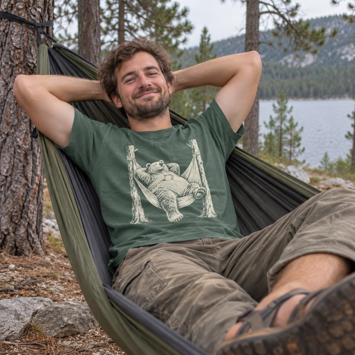 Man relaxing in a hammock wearing the Hammock Grizzly T-Shirt