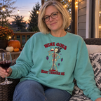 Woman wearing the seafoam Wine Goes Right Through Me sweatshirt on a porch at dusk
