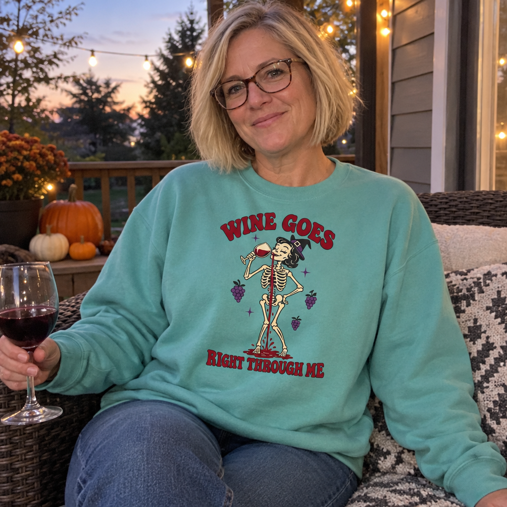 Woman wearing the seafoam Wine Goes Right Through Me sweatshirt on a porch at dusk