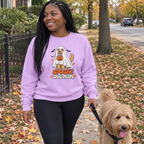 Woman wearing the orchid Spooky Dog Mom sweatshirt walking her goldendoodle on a fall sidewalk