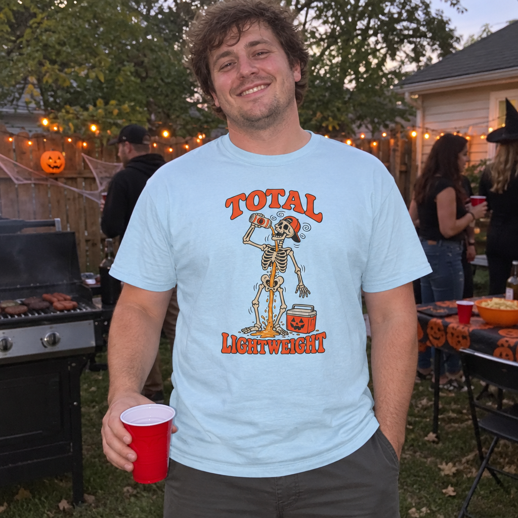 Man wearing the light blue Total Lightweight t-shirt at a backyard Halloween party by the grill