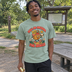 Man wearing the sage Will Go Outside for Snacks t-shirt at a trailhead picnic table