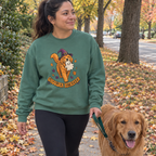 Woman wearing the Light Green Ghoulden Retriever sweatshirt walking her golden retriever
