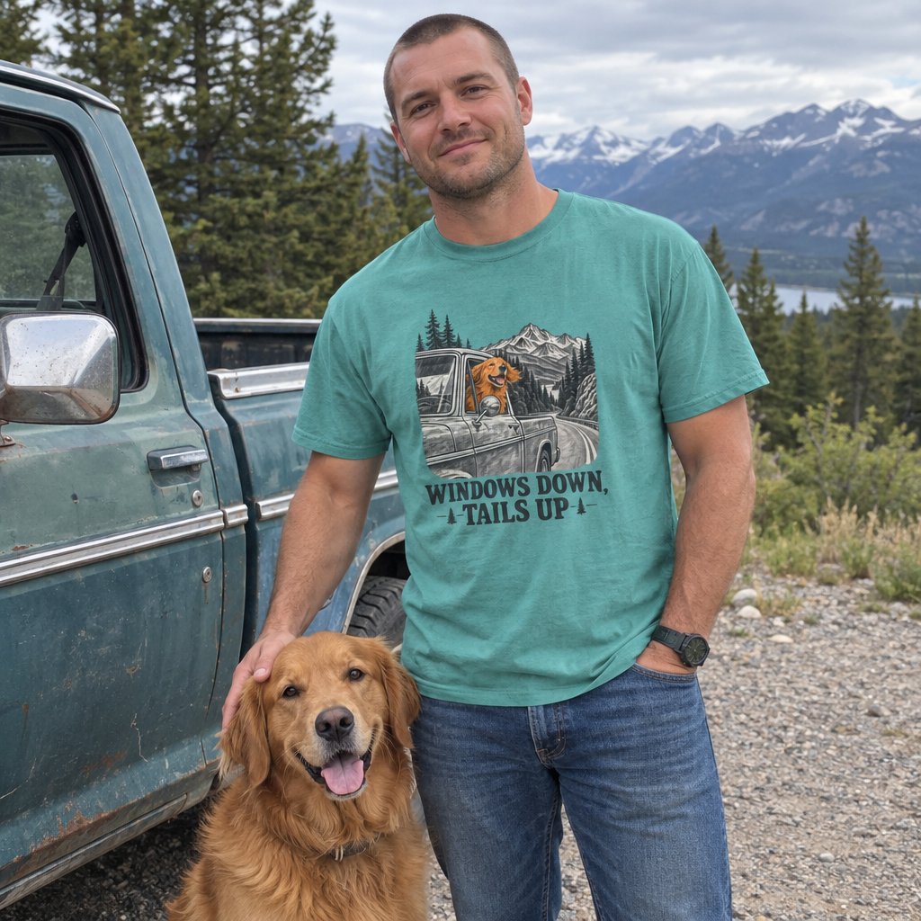 Man wearing the seafoam Windows Down, Tails Up t-shirt by an old pickup with his golden retriever