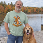 Man wearing the sage Ghoulden Retriever t-shirt on a lake dock with his golden retriever