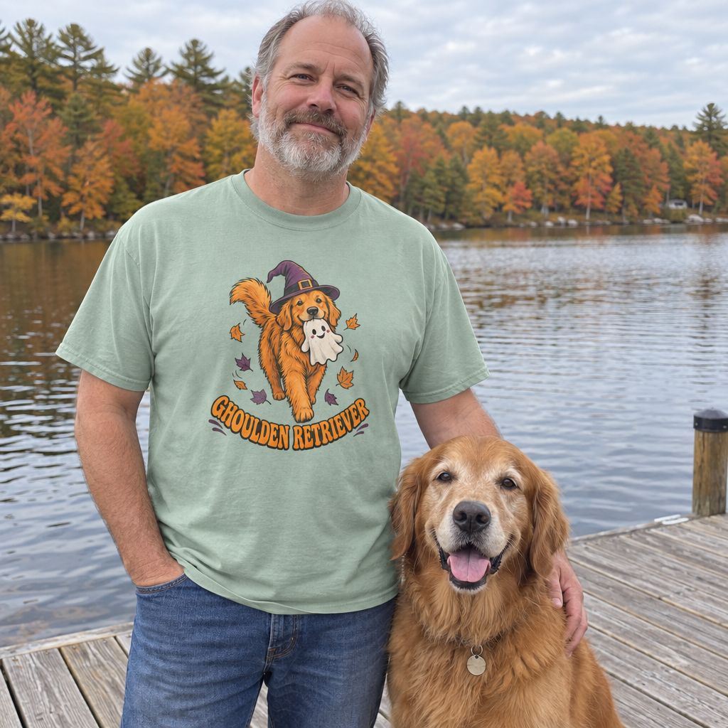 Man wearing the sage Ghoulden Retriever t-shirt on a lake dock with his golden retriever