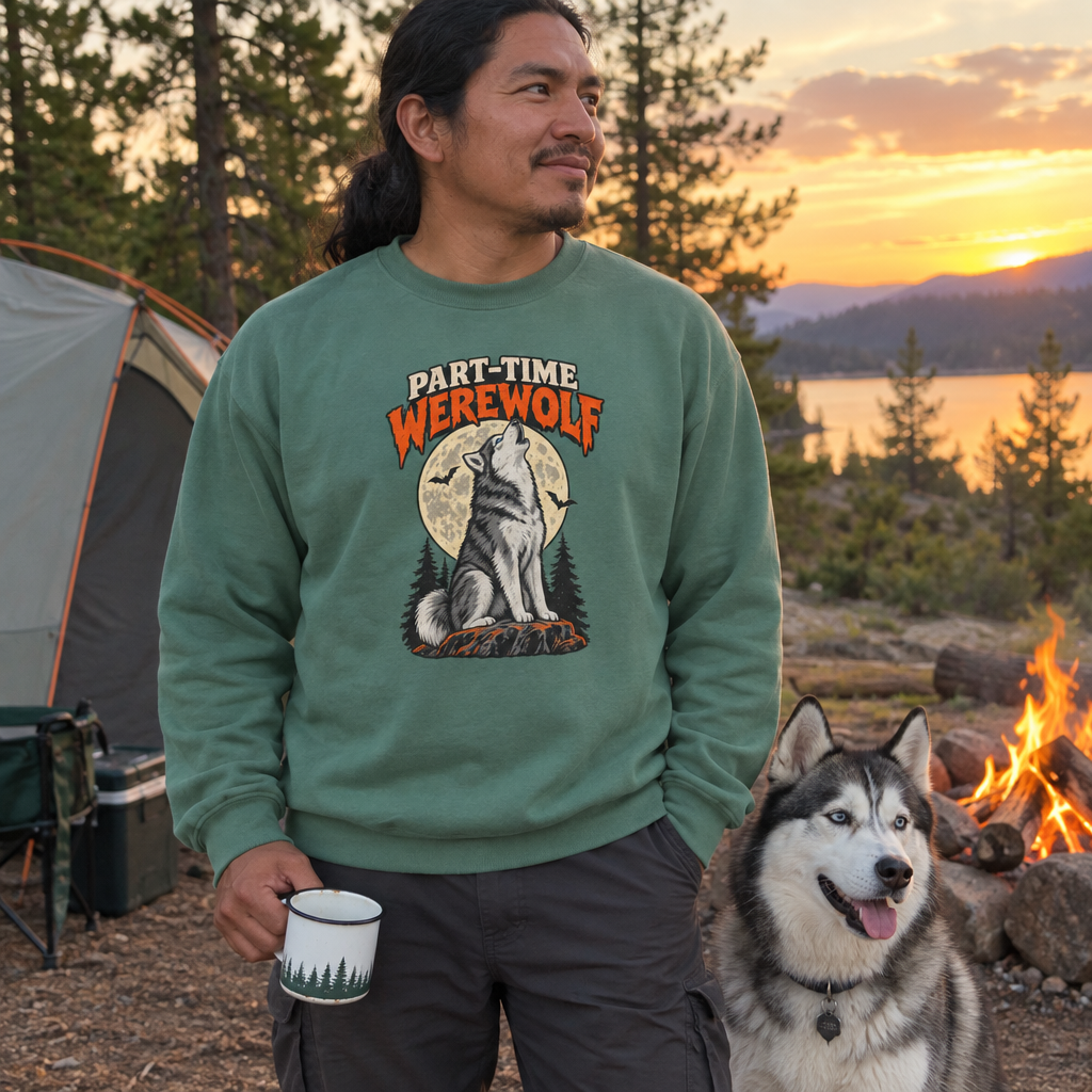 Man wearing the Light Green Part-Time Werewolf sweatshirt at a campsite with his husky