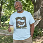 Man wearing the light blue Professional Shade Finder t-shirt by a backyard hammock with lemonade
