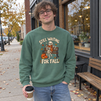 Man wearing the green Still Waiting for Fall sweatshirt outside a coffee shop in autumn