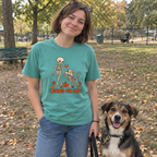 Woman wearing the seafoam Bonded for Life t-shirt at the dog park with her dog