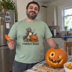 Man wearing the sage green I Carved It Myself t-shirt in the kitchen with his jack-o'-lantern
