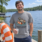 Man wearing the grey Currently Floating t-shirt on a lake dock