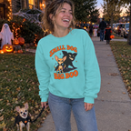 Woman wearing the aqua Small Dog, Big Boo sweatshirt walking her Chihuahua on Halloween night
