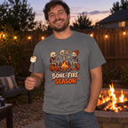 Man wearing the grey Bone-Fire Season t-shirt roasting marshmallows at a backyard fire pit