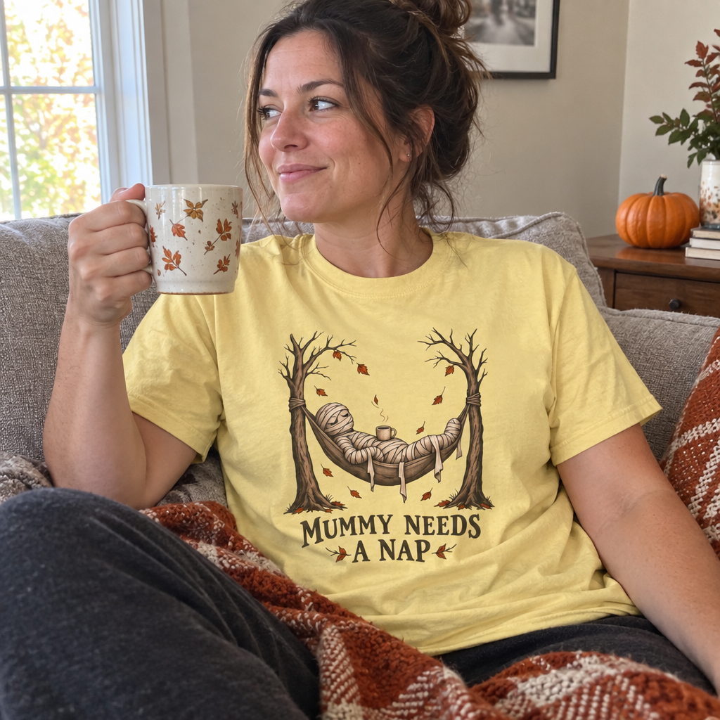 Woman wearing the Mummy Needs a Nap T-Shirt on the couch with coffee
