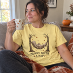 Woman wearing the Mummy Needs a Nap T-Shirt on the couch with coffee