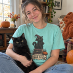 Woman wearing the Certified Bad Luck T-Shirt holding her black cat