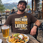 Man wearing the Hike Now Nachos Later T-Shirt with a plate of nachos after a hike