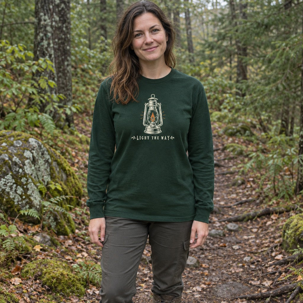 Woman wearing the Light the Way long sleeve shirt on a forest trail
