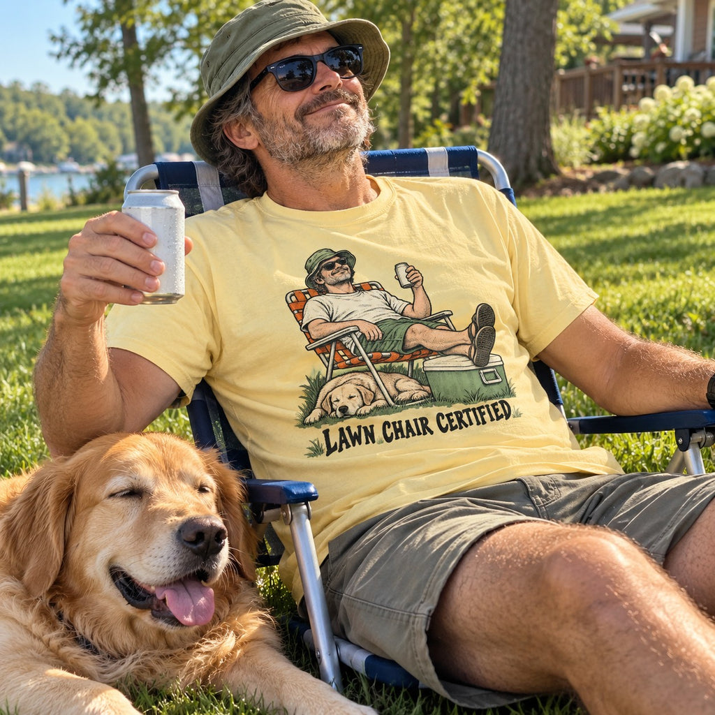 Man relaxing in a lawn chair wearing the Lawn Chair Certified T-Shirt in Butter
