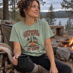 Woman wearing the Leftovers Taste Better at Camp T-Shirt by a campfire