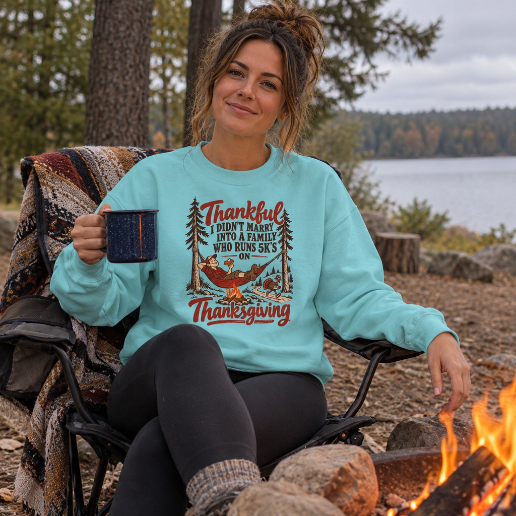 Woman wearing the Thankful Not a 5K Family Sweatshirt by a campfire