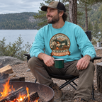 Man wearing the Not a 5K Family Camp Badge Sweatshirt by a campfire