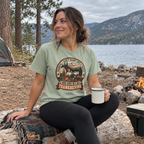 Woman wearing the Not a 5K Family Camp Badge T-Shirt at a lakeside campsite