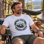 Man wearing the Big Feet, Bigger Naps Bigfoot t-shirt in a camp chair by a hammock