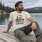 Man wearing the Go Find a Trail T-Shirt sitting on a lake dock